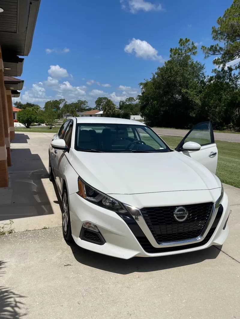 White Nissan sedan after exterior detail in North Port, FL
