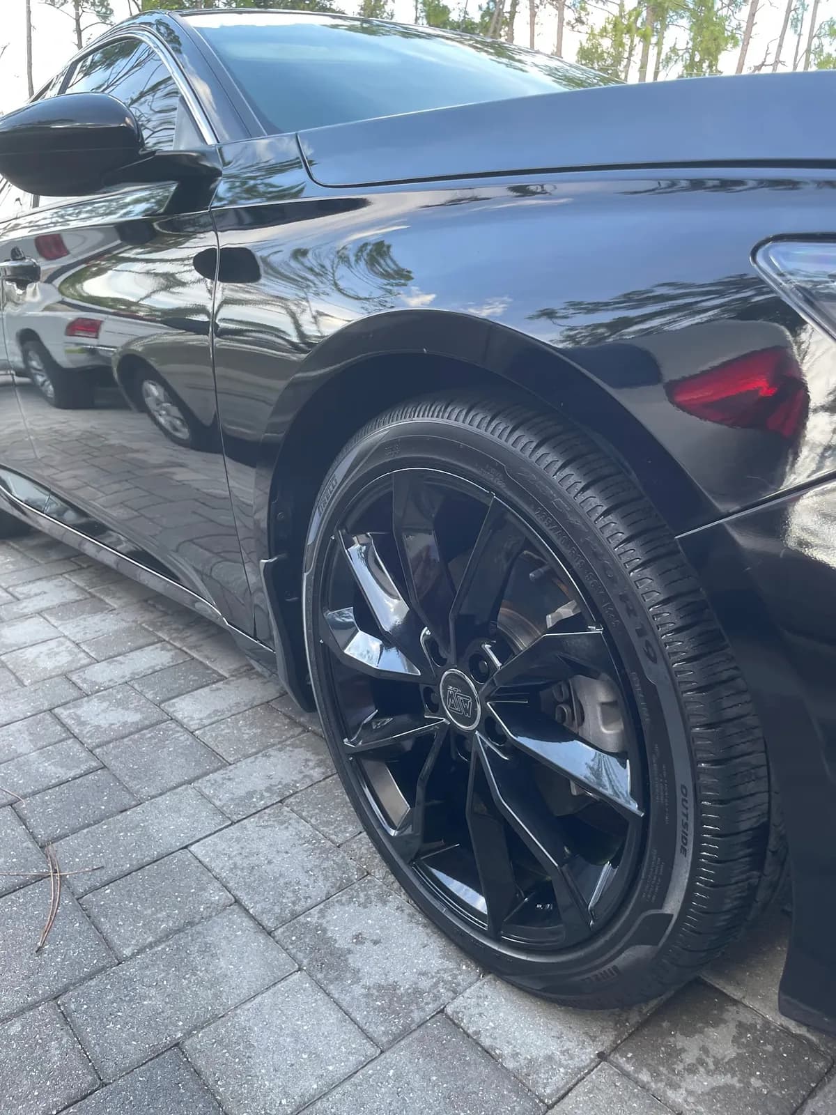 Deep gloss black Audi paint with mirror-like reflections after paint correction by Sansanich Car Detailing in North Port, FL